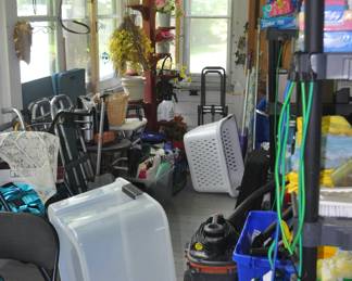 Back porch with some tools, ladders, household and more