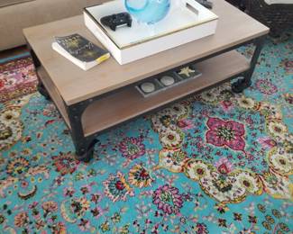 Industrial chic coffee table on wheels; paisley rug
