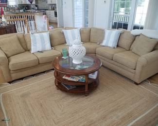 Elegant neutral couch surrounds you with style; area rug