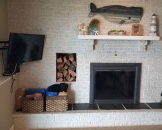 Flat screen TV with mounting bracket; mantel; whale art; storage baskets
