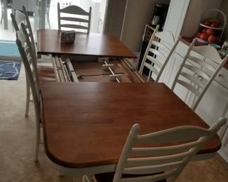 Dining table seats 6; features internal leaves for additional seating