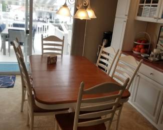 Dining table seats 6; features internal leaves for additional seating