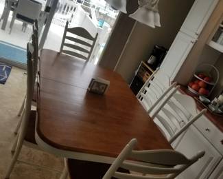 Dining table seats 6; features internal leaves for additional seating