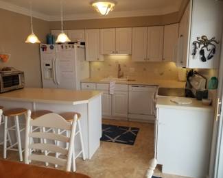 L-shaped kitchen with peninsula; pendant lights