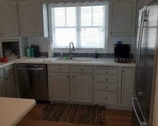 Kitchen cabinets are painted a gray/blue hue