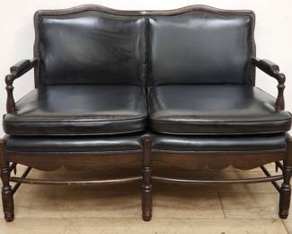 Colonial style faux leather and walnut love seat