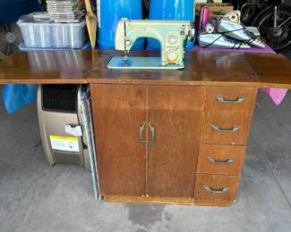 sewing machine in cabinet
