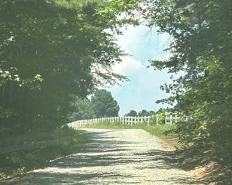 Just before the driveway, look for the white fence