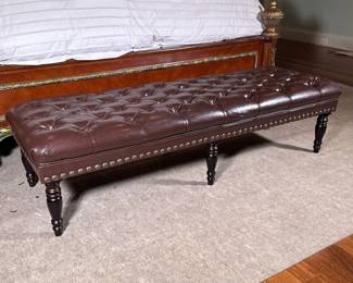 Brown Leather Style Chesterfield Tufted Bench | Rectangular bench with a tufted seat upholstered in a leather-like vinyl material. Featuring a grid of deep button tufts. A row of metal nailhead trim runs along the lower edge. The bench stands on six turned wooden legs. - h. 16.5 x w. 22 x l. 64 in