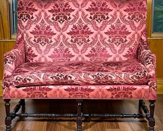 Damask Settee/Loveseat | Tall curved back loveseat in tones of red/cranberry. Dark carved wood stretchers. Cushion is attached by clips. With 3 silver-toned accent pillows included, as pictured - h. 48 x w. 50 x d. 28 in