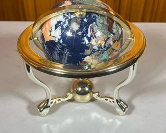Table Top Globe | Black globe spins and tilts. Stand is gold colored plastic. - h. 9 x dia. 9 in