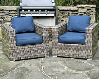 (2pc) WOVEN PATIO CHAIRS WITH CUSHIONS | Having aluminum frame wrapped in all-weather wicker, square arms and a blocky base. Including navy blue outdoor cushions - h. 25.5 x w. 32.5 x d. 33 in (each)