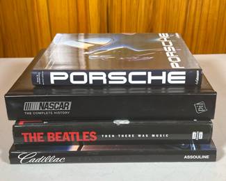 (4pc) Car Themed & Beatles Coffee Table Books | Including a book on Porsches, Cadillacs, and Nascar the Complete History. Beatles book by Tim HIll with rare photographs, ephemera and day-by-day timeline.
Dimensions: w. 10 x l. 12 in (Beatles)