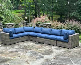 Outdoor Modular Sectional Sofa | Having an aluminum frame wrapped in all-weather wicker, with navy blue outdoor cushions, 7 modular pieces total, including two ends, a corner, and four seats with back rests. Seat h. with cushion 17.5 in. - h. 25.5 x w. 32.5 x d. 33 in (end sections)