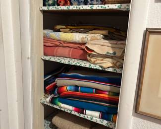 Textiles include Mexican Serapis, vintage linens, and Afghans