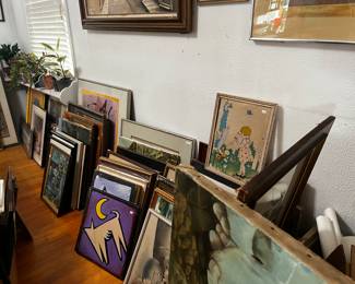 There are rows and rows of art work in the house and outside underneath a shaded area!