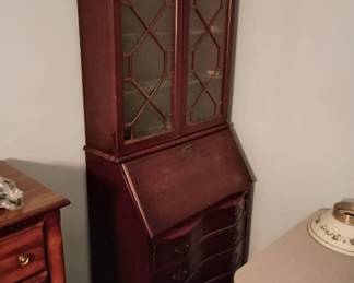 Slant front desk with serpentine style drawers
Upper cabinet with glass doors