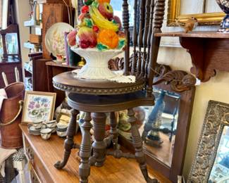 Beautiful old swivel chair, hutch, framed art and topiary piece.
