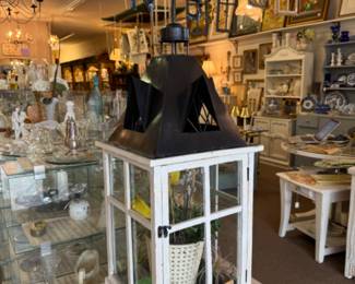 Decorative lantern with a weather vane topper.