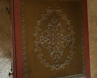 Book inspired cabinet with embossed details
