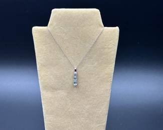 J21 - $120. 10kt white gold chain (17") & 1" Pendant with 2 small diamonds & light blue stones.