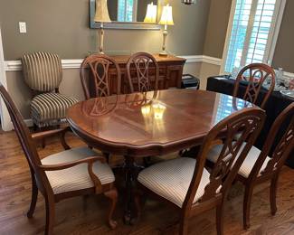 W1 - $250. Universal Furniture Dining Room Table & Chairs. Measures 44.5" wide x 70" deep x 29.5" tall. Has 2 leaves that add 15" each. 2 Captains, 4 regular chairs. Some seats have stains and 1 chair arm is wiggly.