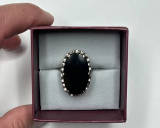 J10 - $240. Size 7. 10kt gold ring with large black stone.