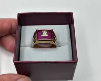 J12 - $400. Size 11 Mens 10kt gold ring. Large red stone with inset diamond.