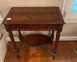W58 - $225. Four Corner Imports "Crotch Veneer Side Table" from Whitley Furniture Galleries. Measures 27" wide x 16" deep x 30" tall. Gently used in formal living area! Wood with Metal Accents. Single Drawer.