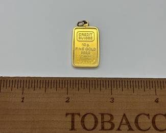J18 - $1200. 10 grams of fine gold .999 from Credit Suisse in a 14kt charm surround.