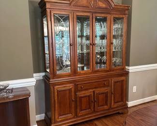 W9 - $250. Alexander Julian Lighted China Cabinet. Measures 61" wide x 18" deep x 85" tall. (Base is 32.5" Top is 53" tall) Has 2 glass shelves. Overall very good condition but does have minor signs of wear. Moves in two pieces.