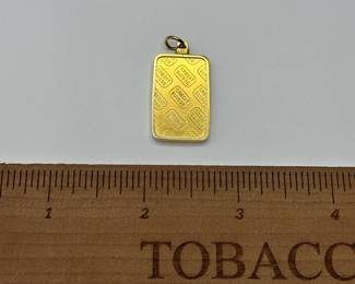 J18 - $1200. 10 grams of fine gold .999 from Credit Suisse in a 14 kt charm surround.