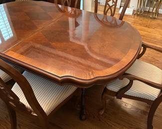 W1 - $250. Universal Furniture Dining Room Table & Chairs. Measures 44.5" wide x 70" deep x 29.5" tall. Has 2 leaves that add 15" each. 2 Captains, 4 regular chairs. Some seats have stains and 1 chair arm is wiggly.