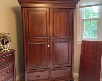 W70 - $200. Durham Cabinet Company solid wood Media or Clothes Armoire Has 2 adjustable/removable shelves and a bar to hang clothes. Bottom 2 drawers are cedar. SOLID piece. You will need *AT LEAST* 2 people to carry this out of the home. *NO* wheeled devices can be used on the floors. Measures 52.5" wide x 46.5" deep x 80.25" tall.