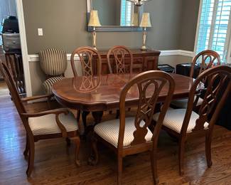 W1 - $250. Universal Furniture Dining Room Table & Chairs. Measures 44.5" wide x 70" deep x 29.5" tall. Has 2 leaves that add 15" each. 2 Captains, 4 regular chairs. Some seats have stains and 1 chair arm is wiggly.