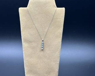 J21 - $120. 10kt white gold chain (17") & 1" Pendant with 2 small diamonds & light blue stones.
