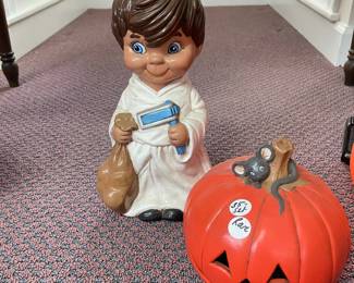 W131 - $35. Ceramic child with jack-o-lantern mask.