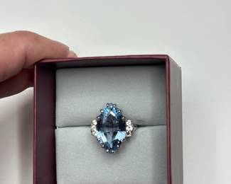 J3 - $500. Size 5.5. 14kt gold. (Aquamarine or Blue Topaz Stone.) Missing one small diamond.