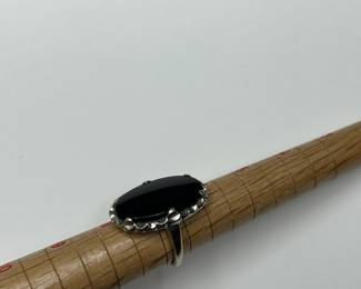 J10 - $240. Size 7. 10kt gold ring with large black stone.