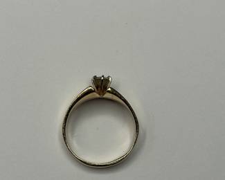 J13 - $400. Size 9. Ladies 14 kt gold ring with center diamond.