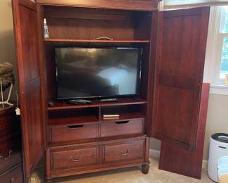 W70 - $200. Durham Cabinet Company solid wood Media or Clothes Armoire Has 2 adjustable/removable shelves and a bar to hang clothes. Bottom 2 drawers are cedar. SOLID piece. You will need *AT LEAST* 2 people to carry this out of the home. *NO* wheeled devices can be used on the floors. Measures 52.5" wide x 46.5" deep x 80.25" tall.