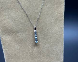 J21 - $120. 10kt white gold chain (17") & 1" Pendant with 2 small diamonds & light blue stones.