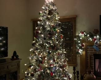 9’ Christmas Flocked, high end flocked. Remote control pre lighted tree clear or colored several modes. Assembly includes electrical connections, very easy set up. This is from Sam’s Club. 