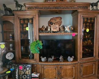 Very large entertainment center,more stained glass pieces animals and Budweiser Beer Steins and elephant