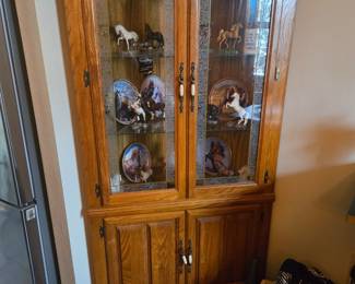 Beautiful corner cabinet with multiple horse statues and plates etc.