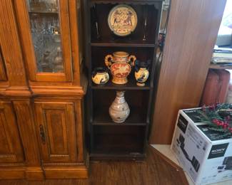Small bookshelf with some Greek looking vases