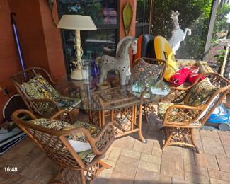 A rattan and glass table and chairs...could use some slight work