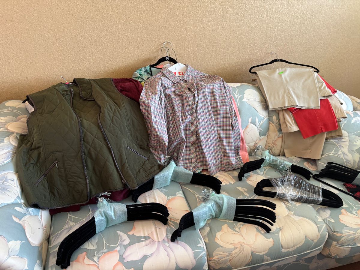 Women’s clothing and bundles of JM hangers.