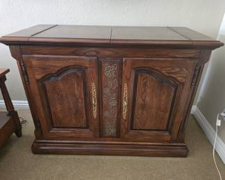 Vintage rolling buffet cabinet with flip-up expanding top.