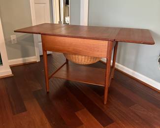 C88 - $850. 1950's Sewing Table AT-33 Hans Wegnar (by Anders Tuck) Minor imperfection noted in the picture. Measures 25.5" wide x 22.5" deep x 24" tall. Two Drop leaves are each 10.75" wide.